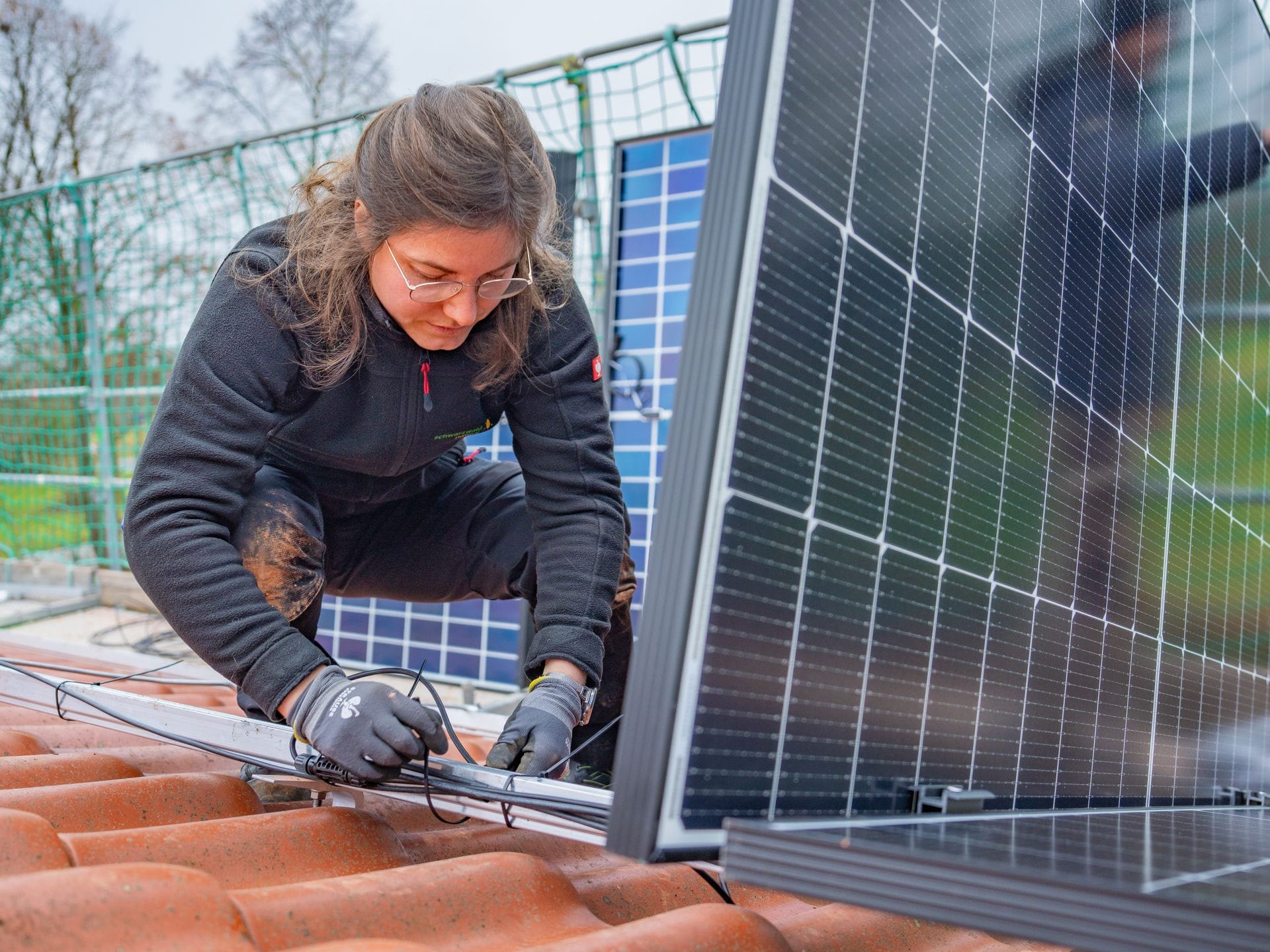 Mona Keppeler, Mitarbeiterin der Schwarzwald Nature GmbH, bei der Installation von 
Solarpanels.
